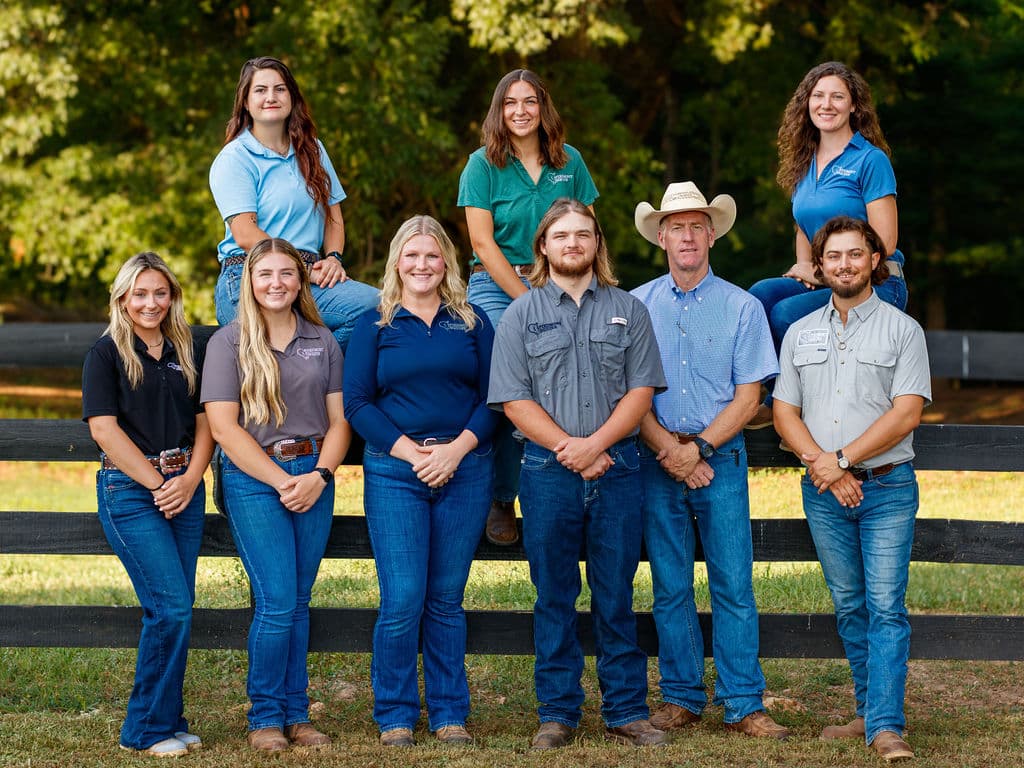 Piedmont Equine Associates staff members leaning against fence